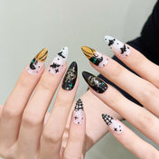 Medium Almond acrylic nails featuring glitter pumpkins, flying bats and spooky web details
