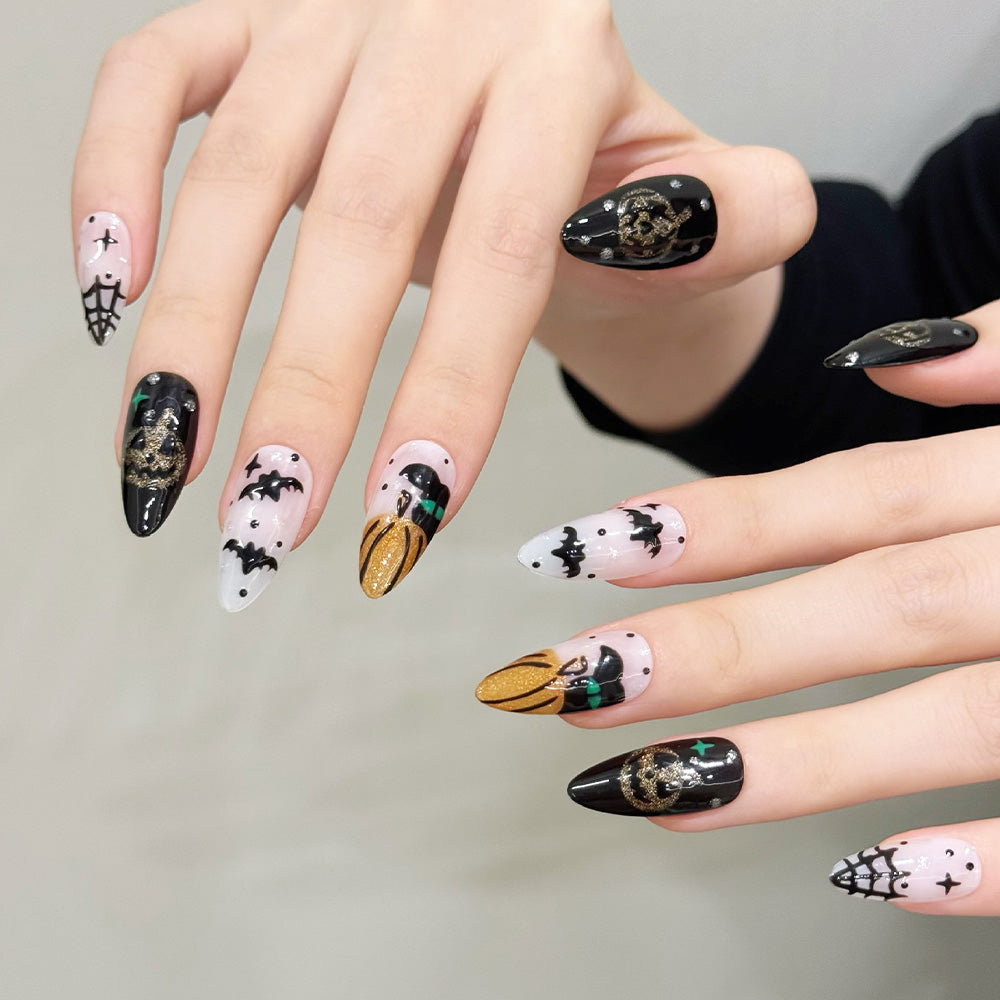 Charmeenail reusable press-on nails in black, gold and white with jack-o-lantern nail art
