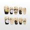 Handmade beige Halloween press on nails with ghost face, black cat and spiderweb design