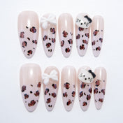 Long almond press-on nails with leopard print, 3D white bow, and cute cat face