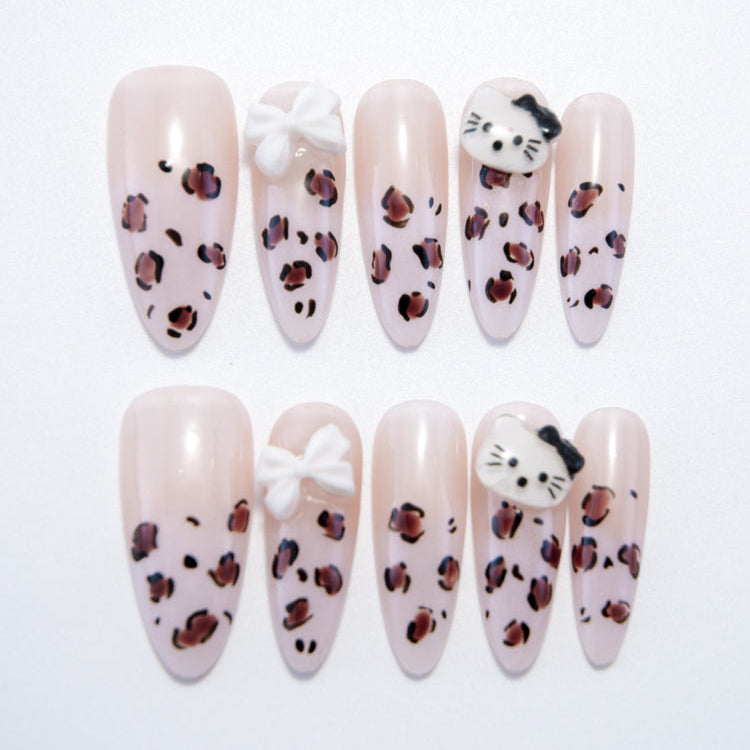 Long almond press-on nails with leopard print, 3D white bow, and cute cat face