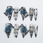 Gothic black and silver press-on nails with 3D blue roses, lace, and crystal gems