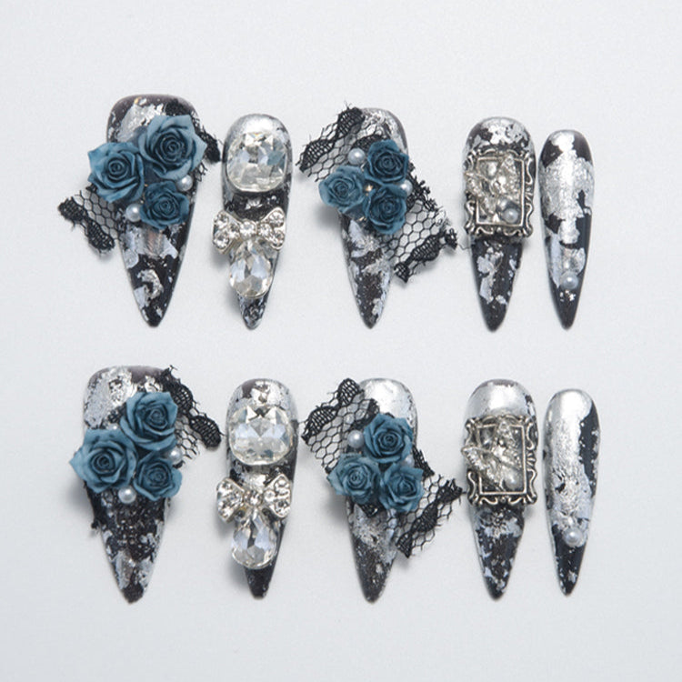 Gothic black and silver press-on nails with 3D blue roses, lace, and crystal gems