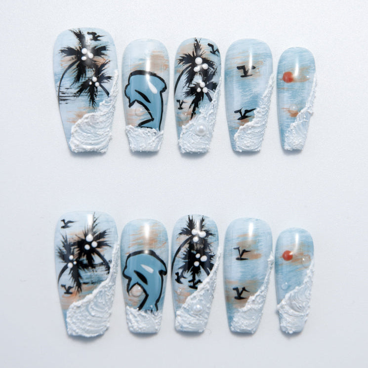 Summer beach press-on nails with dolphin, palm tree, and ocean wave designs