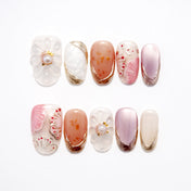 Handmade pink and nude nails with gold accents and seashell-inspired art