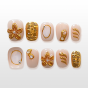 Nude press-on nails with gold 3D floral and abstract metallic designs