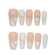 Handmade bridal nails featuring blush pink gradient, pearl beads, and crystal decorations