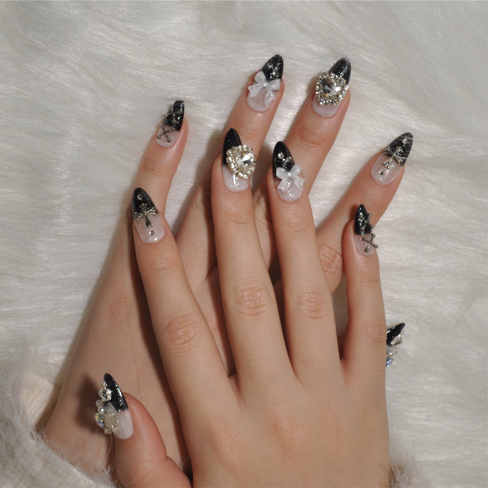 Black ombre nails with silver crossbones, crystal heart, and shimmer