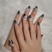 Black ombre nails with silver crossbones, crystal heart, and shimmer