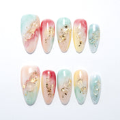 Pastel marble press-on nails with pink, blue, yellow gradients and gold foil