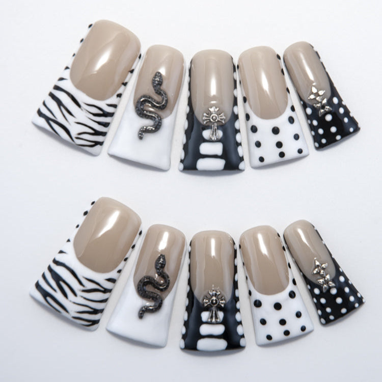 Handmade long nails in nude, black, and white with animal print and metallic snake accents