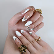 Elegant French tip press-on nails with nude base and metallic star accents