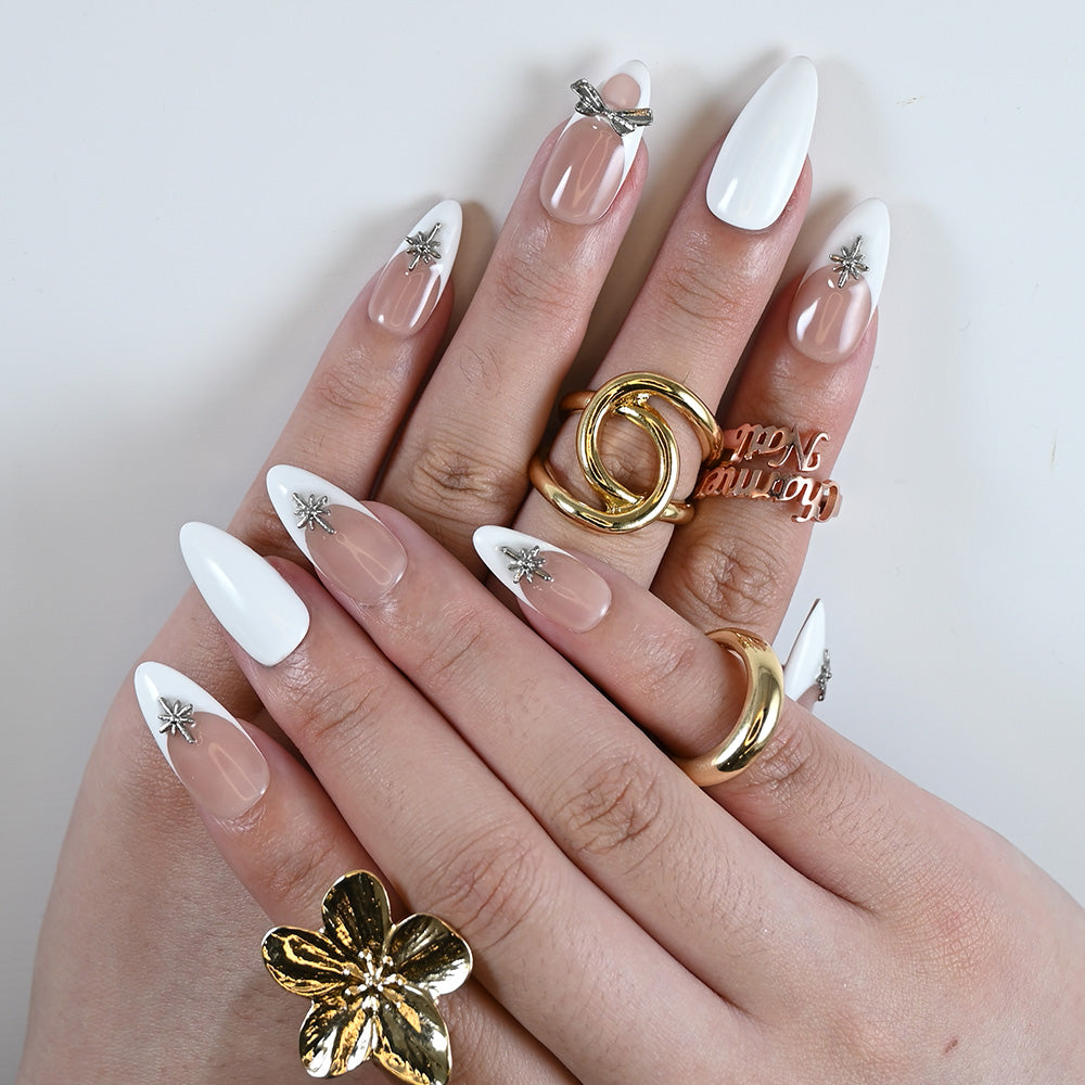 Minimalist nude and white press-on nails with 3D silver bow and star details