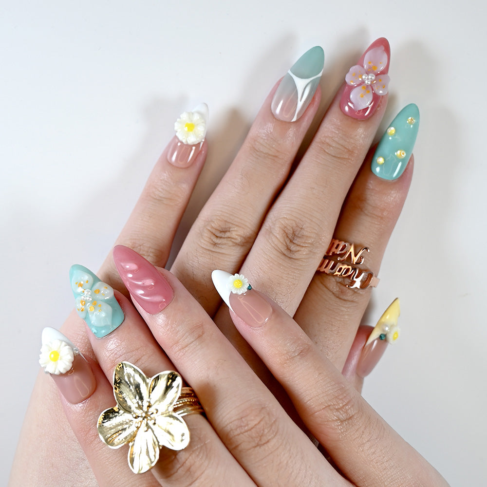 Fresh floral press-on nails with daisies, soft ombre, and colorful summer tones