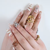 Handmade bridal press-on nails with silver bows, 3D pearls, and French manicure style