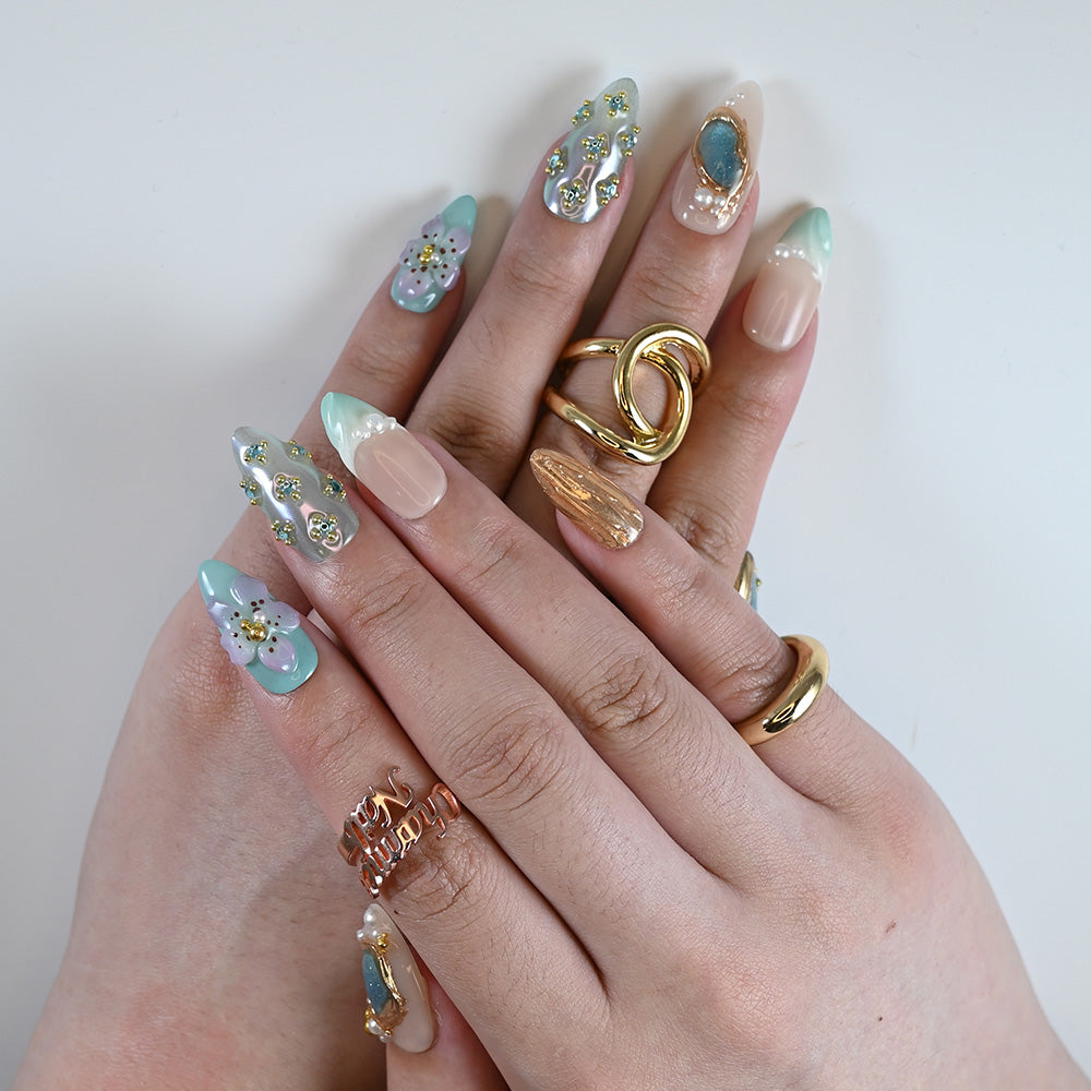 Handmade press-on nails with turquoise gemstone effect, pastel swirls, and delicate pearls