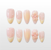 Nude French tip press-on nails with pearl accents and 3D pink flower design