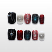 Galaxy-inspired press-on nails with black, red, and silver metallic accents