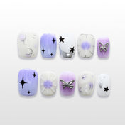 Purple and white gradient press-on nails with black star designs and silver butterfly charm